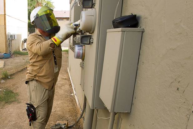 A NV Energy employee puts a cap on an empty meter socket during a County Multi-Agency Response Team (CMART) operation at a neighborhood near Twain Avenue and Decatur Boulevard Wednesday, Oct. 10, 2012. Their efforts follow the "broken windows" theory - if a neighborhood can be kept up, it is less likely to have rampant crime.