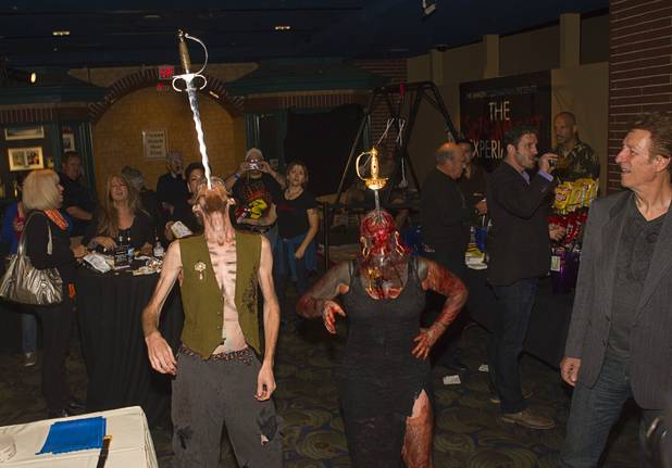 Kelvikta the Blade and Andrew S. of the SwingShift SideShow swallow swords during a VIP/media night event at the Amazing Jonathan's SCREAMont Experiment haunted hotel at the Las Vegas Club in downtown Las Vegas Thursday, Oct. 10, 2012. The haunted hotel is open nightly from 7 p.m. to midnight.
