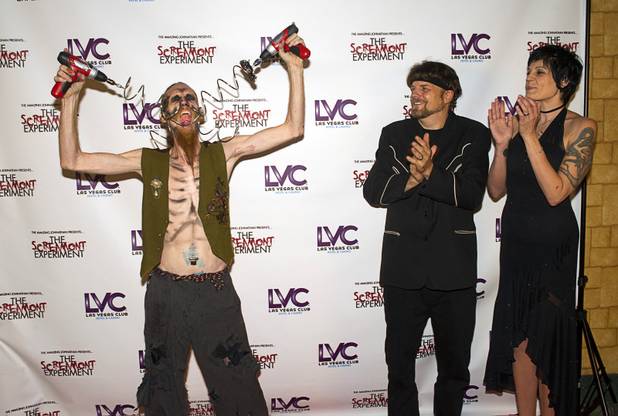 Andrew S. performs on the red carpet as the Amazing Jonathan and Anastasia Synn applaud during a VIP/media night event at Jonathan's SCREAMont Experiment haunted hotel at the Las Vegas Club in downtown Las Vegas Thursday, Oct. 10, 2012. The haunted hotel is open nightly from 7 p.m. to midnight.