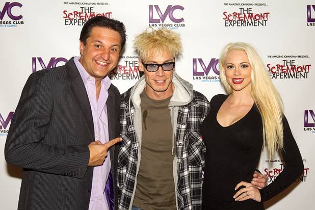Magician Murray SawChuck, center, arrives with sidekick Douglas "Lefty" Leferovich and his wife Chloe Crawford for a VIP/media night event at the Amazing Jonathan's SCREAMont Experiment haunted hotel at the Las Vegas Club in downtown Las Vegas Thursday, Oct. 10, 2012. The haunted hotel is open nightly from 7 p.m. to midnight. SawChuck has a comedy/magic show at the Tropicana. Crawford is a dancer in the show.