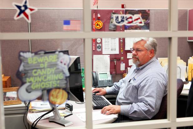Coroner investigator Richard Jones works in his office at the Clark County Office of the Coroner/Medical Examiner in Las Vegas on Thursday, October 11, 2012.