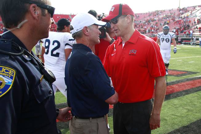 UNLV coach Bobby Hauck and UNR coach Chris Ault shake hands after their game Saturday, Oct. 13, 2012 at Sam Boyd Stadium. UNR came from behind and won the game, for the eighth consecutive time, 42-37.