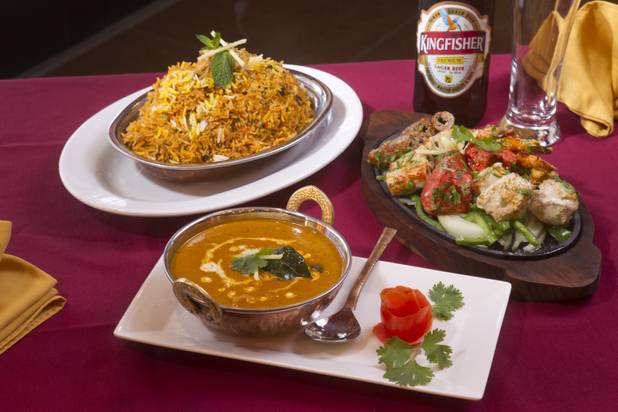 Clockwise from top right, Saffron biryabi, a mixed Saffron platter, and Chicken Madras curry at Saffron Flavors of India restaurant, 4450 N. Tenaya Way, Sunday, Oct. 14, 2012.