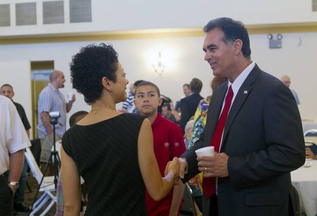 Danny Tarkanian, candidate for the state's 4th Congressional District, greets Sonya Horsford, wife of candidate Steven Horsford, before a debate at Temple Sinai of Las Vegas in Summerlin Sunday, Oct. 14, 2012. The temple's Men's Club sponsored the debate.