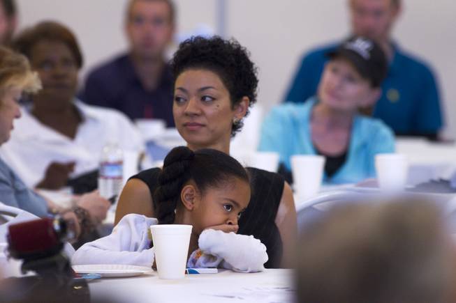 Ella Horsford, 5, sits on her mothers lap as she listens to her father Steven Horsford debate with Danny Tarkanian debate at Temple Sinai of Las Vegas in Summerlin Sunday, Oct. 14, 2012. The temple's Men's Club sponsored the debate.