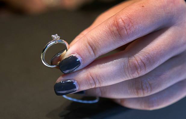 A diamond engagement ring is displayed at Tiffany and Co. in the Crystals retail mall Monday, Oct. 15, 2012. This ring is priced at $1275.00 but prices for diamond engagement rings go as high as $488, 500.00.