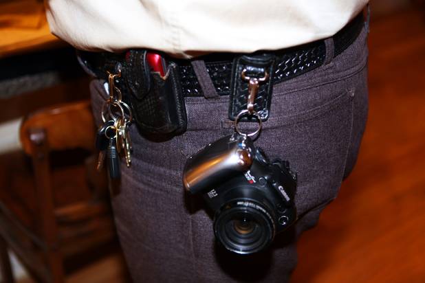 Coroner investigator Richard Jones has his camera at the ready to take photos of the scene where a dead body was found in North Las Vegas.