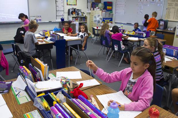 Third grader Meena Boix reads a student's name after pulling the name from a container at Lomie Heard Elementary School on Nellis Air Force Base Tuesday, Oct. 16, 2012. The sticks determine the next student to answer a question. The school is the only Clark County school on a military base.