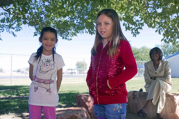 Third graders Audrey Zeller, left, and McKenna McGough pose at Lomie Heard Elementary School on Nellis Air Force Base Tuesday, Oct. 16, 2012. Pamela Goynes-Brown, assistant principal, looks on at right. The school is the only Clark County school on a military base.