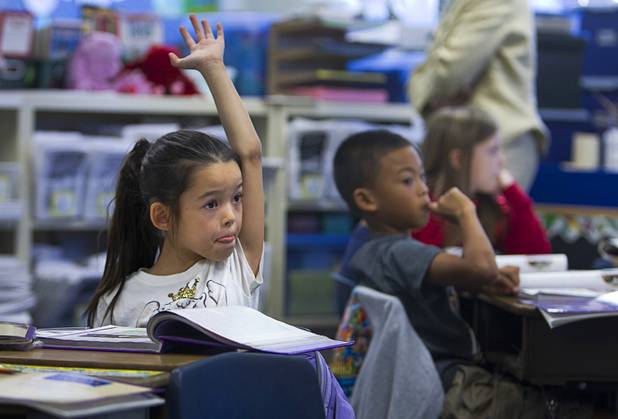Third grader Audrey Zeller raises her hand during class at Lomie Heard Elementary School on Nellis Air Force Base Tuesday, Oct. 16, 2012. The school is the only Clark County school on a military base.