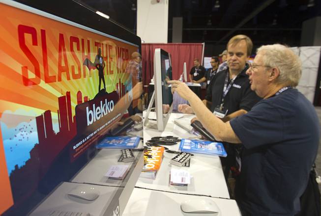Robert Carlton, right, looks over a display with blekko's Daniel Swartz during PubCon, a social media and optimization conference, at the Las Vegas Convention Center Wednesday, Oct. 17, 2012. Blekko is a web search engine.