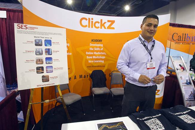 German Chavez mans the ClickZ booth during PubCon, a social media and optimization conference, at the Las Vegas Convention Center Wednesday, Oct. 17, 2012.