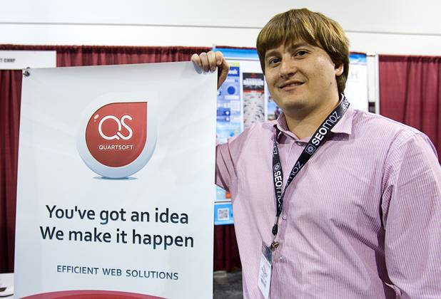 Pauyl Ryazanov, president of Quartsoft, poses at the company's booth during PubCon, a social media and optimization conference, at the Las Vegas Convention Center Wednesday, Oct. 17, 2012.