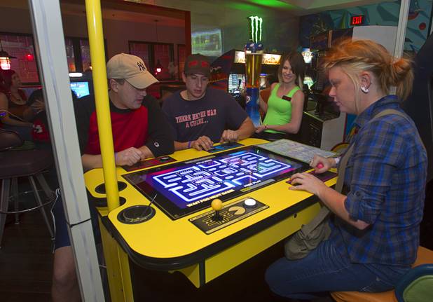 Customers, from left, John Molette, Chris Trippiedi and Rosie Moran play Pacman in Hi Scores, a bar-arcade at Stephanie Street and Paseo Verde Parkway, in Henderson Thursday, Oct. 18, 2012. A second Hi Scores location is opening this fall.