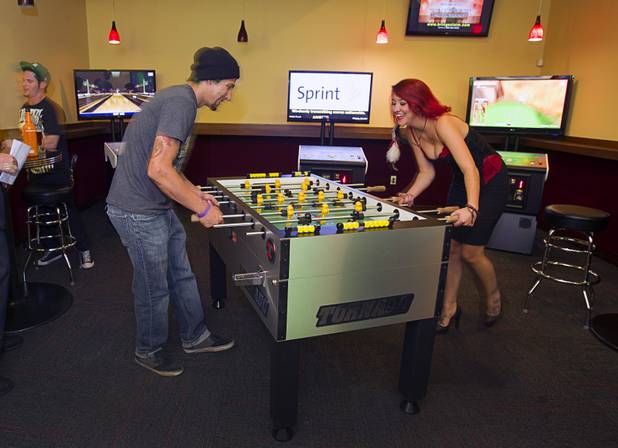 Anthony Neuman and Sloan Ferguson play foosball in the games area of the Players Club, a bar at Stephanie Street and Paseo Verde Parkway, in Henderson Thursday, Oct. 18, 2012.