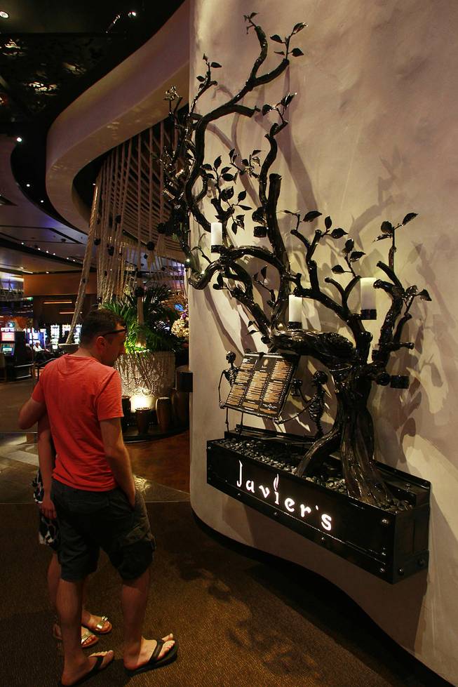 Skeletons hold the menu board at Javier's in Aria Oct. 18, 2012.