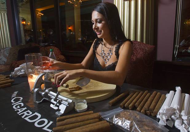 Cigar Doll Katrina Kelley rolls a cigar during a private party in the Foundation Room at the Mandalay Bay Sunday, Oct. 21, 2012. Cigar Dolls is a company that provides attractive cigar rollers for corporate events or private parties.