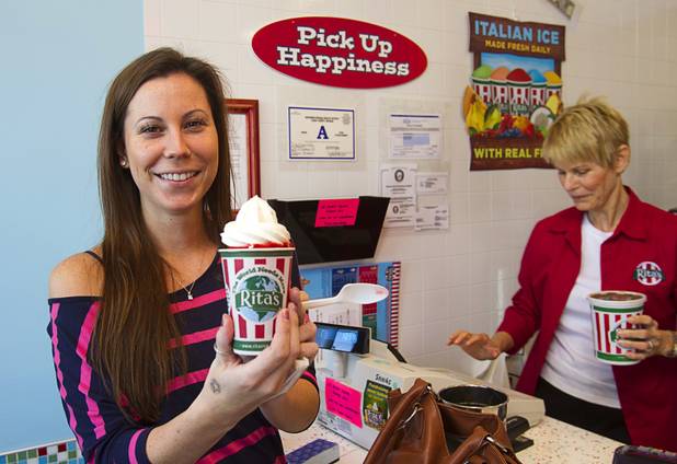 Customer Holly Knowlton, left, poses with a cup of "Swedish Fish" Italian ice with frozen custard on at Rita's Green Valley, a custard and Italian ice shop in Henderson, Sunday, Oct. 21, 2012. Rita's, on Stephanie Street just north of Sunset Road, is the first Nevada franchise of a popular East Coast chain that originated in Bensalem Township, Penn.