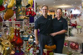 Owners Dave Kimler and his wife Beth Tom pose at Santa's Wrap, a holiday store in The District, in Henderson Sunday, Oct. 21, 2012.