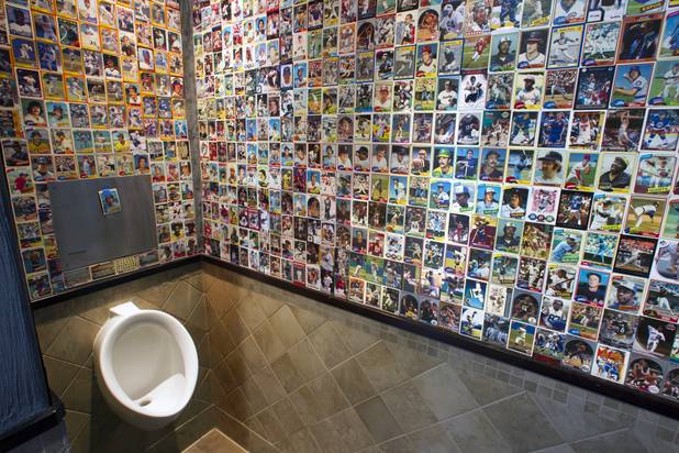 The men's restroom is shown at Honey Salt, a new restaurant at 1031 S Rampart Blvd, Monday, Oct. 22, 2012.  The wall is decorated with baseball cards.