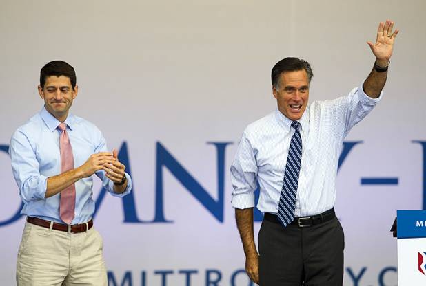 Republican presidential candidate Mitt Romney waves during a campaign rally at the Henderson Pavilion Tuesday, Oct. 23, 2012. Running mate Paul Ryan is at left.