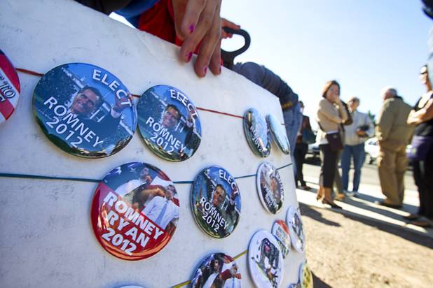 A vendor displays buttons as supporters wait in line for the Mitt Romney-Paul Ryan campaign rally at the Henderson Pavilion Tuesday, Oct. 23, 2012.