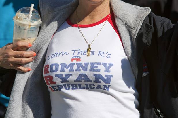A woman shows off her T-shirt as she waits in line for the Mitt Romney-Paul Ryan campaign rally at the Henderson Pavilion Tuesday, Oct. 23, 2012.