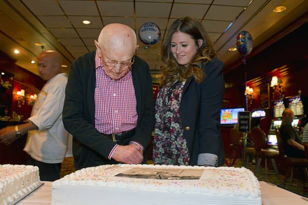 Las Vegas gaming pioneer Jackie Gaughan cuts a cake as Alexandra Epstein, executive vice president of the El Cortez, looks on as he celebrates his 92nd birthday with a champagne and cake celebration at the El Cortez in downtown Las Vegas, Wednesday, Oct. 24, 2012.