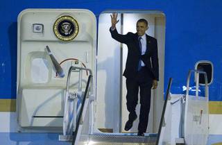 President Barack Obama waves from Air Force One after arriving at McCarran International Airport Wednesday, Oct. 24, 2012.