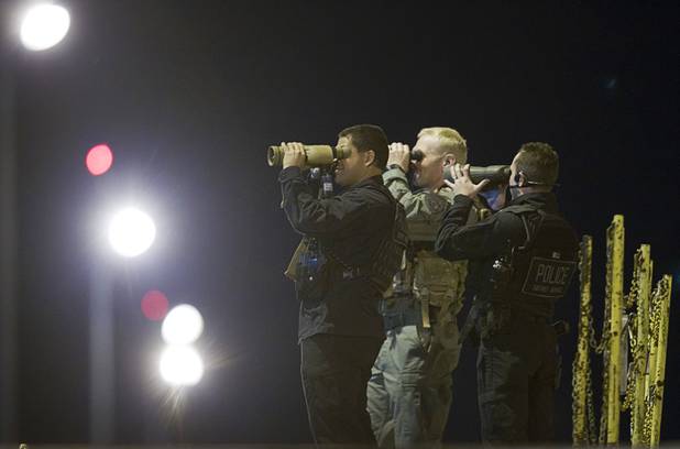 A security detail keeps an eye out while they wait for President Barack Obama at McCarran International Airport Wednesday, Oct. 24, 2012.