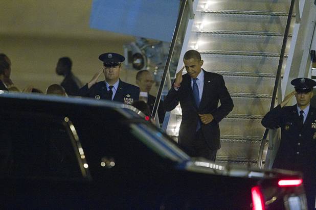 President Barack Obama salutes after deplaning Air Force One after arriving at McCarran International Airport Wednesday, Oct. 24, 2012.