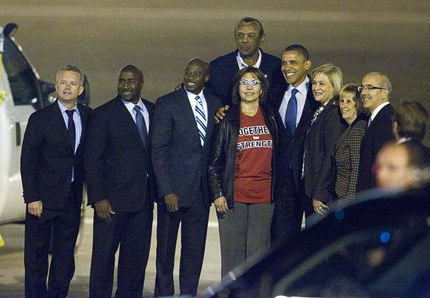 President Barack Obama poses for a photo with local Democrats after arriving at McCarran International Airport Wednesday, Oct. 24, 2012.