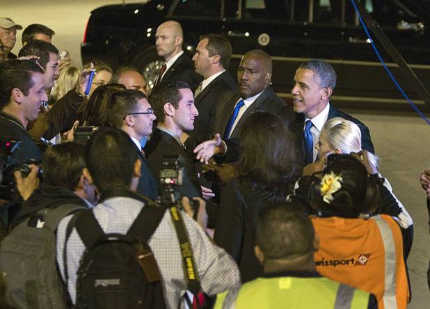President Barack Obama greets guests after arriving at McCarran International Airport Wednesday, Oct. 24, 2012.