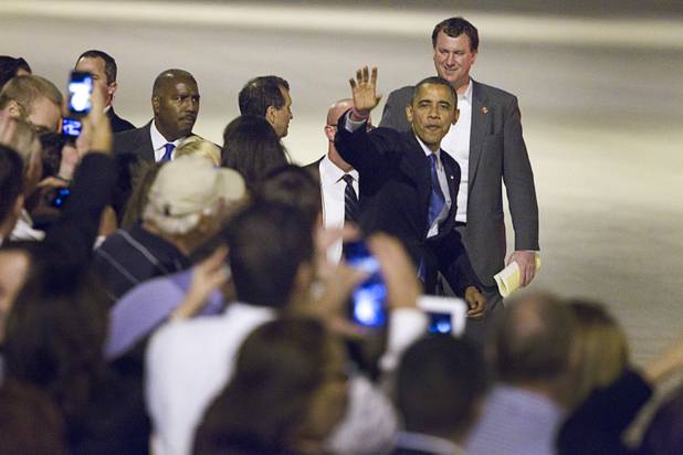 President Barack Obama waves to guests before leaving at McCarran International Airport Wednesday, Oct. 24, 2012.