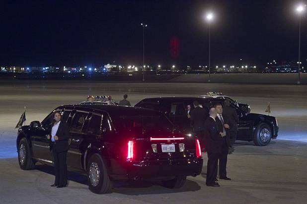 Secret service agents stand by President Barack Obama's limousine as he prepares to leave for a campaign rally Wednesday, Oct. 24, 2012.