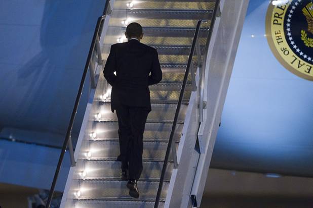 President Barack Obama climbs the stars to Air Force One at McCarran International Airport after a campaign rally in Las Vegas Wednesday, Oct. 24, 2012.