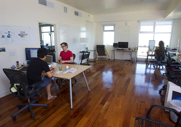Phu Ngyuen, left, one of the three Romotive founders, talks with software engineer James Knight in the "Software Cave" at the Romotive offices in downtown Las Vegas Wednesday, Oct. 24, 2012. The new Romo smartphone robot with enhanced features can be ordered on kickstarter.com and is featured in the Neiman Marcus Holiday catalog.