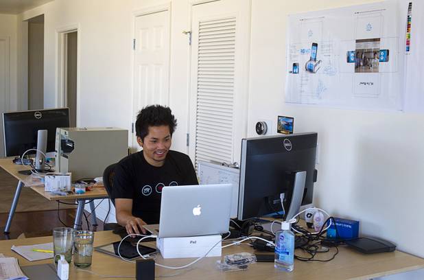 Phu Ngyuen, left, one of the three Romotive founders, works in the "Software Cave" at the Romotive offices in downtown Las Vegas Wednesday, Oct. 24, 2012. The new Romo smartphone robot with enhanced features can be ordered on kickstarter.com and is featured in the Neiman Marcus Holiday catalog.