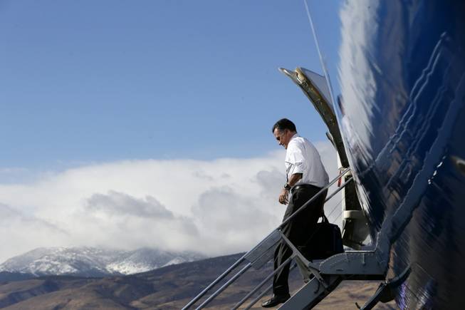 With the Reno Mountains in the background, Republican presidential candidate, former Massachusetts Gov. Mitt Romney steps off his campaign plane at Reno-Tahoe International Airport in Reno, Nev., Wednesday, Oct. 24, 2012, before traveling to a campaign rally at the Reno Events Center. 