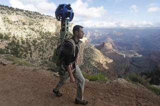In this Monday Oct. 22, 2012, photo, Google product manager Ryan Falor walks with the Trekker during a demonstration for the media along the Bright Angel Trail at the South Rim of the Grand Canyon National Park in Arizona. 