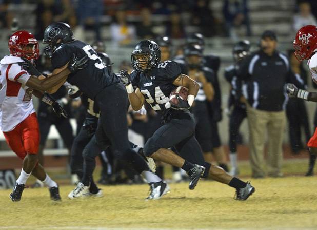 Palo Verde High School's Ryan Beaulieu, center, carries the ball for Palo Verde's first touchdown against Arbor View at Palo Verde Thursday, Oct. 25, 2012. Arbor View beat Palo Verde 35-29.