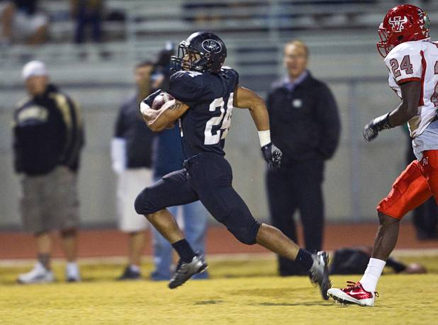 Palo Verde High School's Ryan Beaulieu, left, outruns Arbor View's Anthony Smith for Palo Verde's first touchdown against Arbor View at Palo Verde Thursday, Oct. 25, 2012. Arbor View beat Palo Verde 35-29.