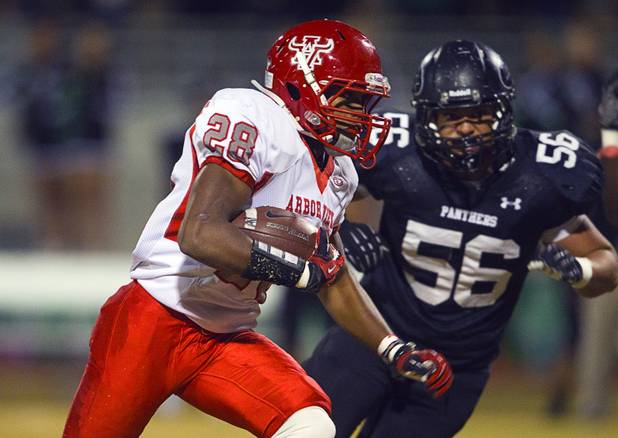 Arbor View's Jacob Speaks carries the ball past Palo Verde's Josh Hamilton during a game at Palo Verde Thursday, Oct. 25, 2012. Arbor View beat Palo Verde 35-29.
