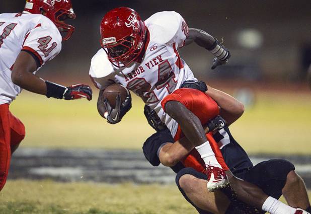 Arbor View's Anthony Smith is tackled by Palo Verde's Christian D'Orazio-Martin during a game at Palo Verde Thursday, Oct. 25, 2012. Arbor View beat Palo Verde 35-29.