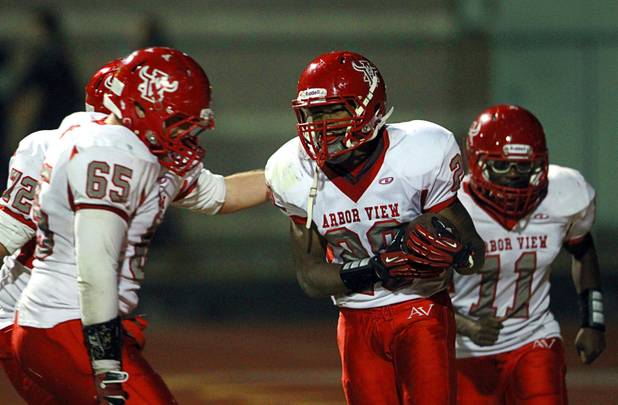 Arbor View's Jacob Speaks, center, is congratulated by teammates after scoring what would be the winning touchdown against Palo Verde Thursday, Oct. 25, 2012. Arbor View beat Palo Verde 35-29.