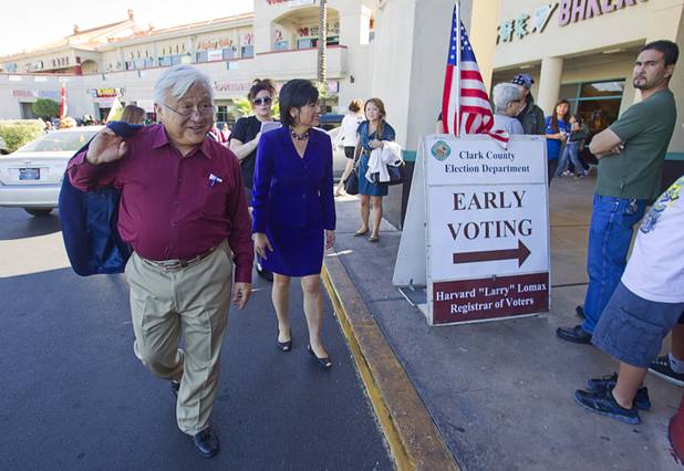 California Congressman Mike Honda and Congresswoman Judy Chu walk by an early voting site after an Asian American and Pacific Islander event at the Chinatown Mall on Saturday, Oct. 27, 2012.