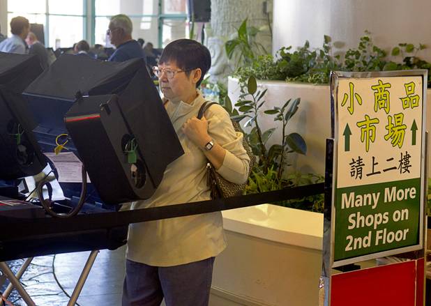 A woman casts her ballot at an early voting site at the Chinatown Mall on Saturday, Oct. 27, 2012.
