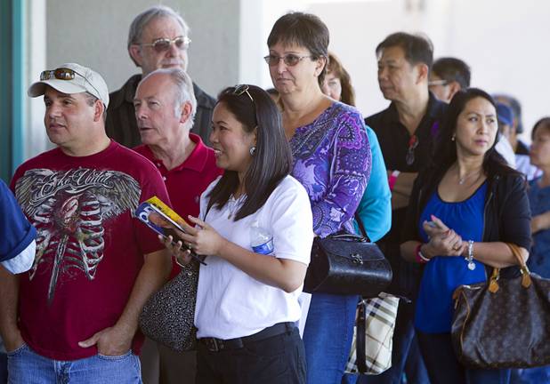 Voters wait in line at an early voting site at the Chinatown Mall on Saturday, Oct. 27, 2012.