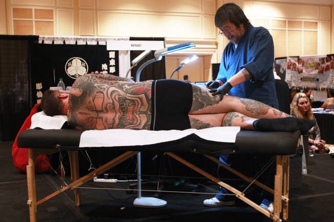 Artist Horitoshi 1 uses a traditional Japanese tattooing technique called Tebori at Mario Barth's Biggest Tattoo Show on Earth at the Mirage on Saturday, Oct. 27, 2012.