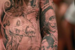 A man displays his tattoos, including Salvador Dali, at Mario Barth's Biggest Tattoo Show On Earth at the Mirage Saturday, Oct. 27, 2012.